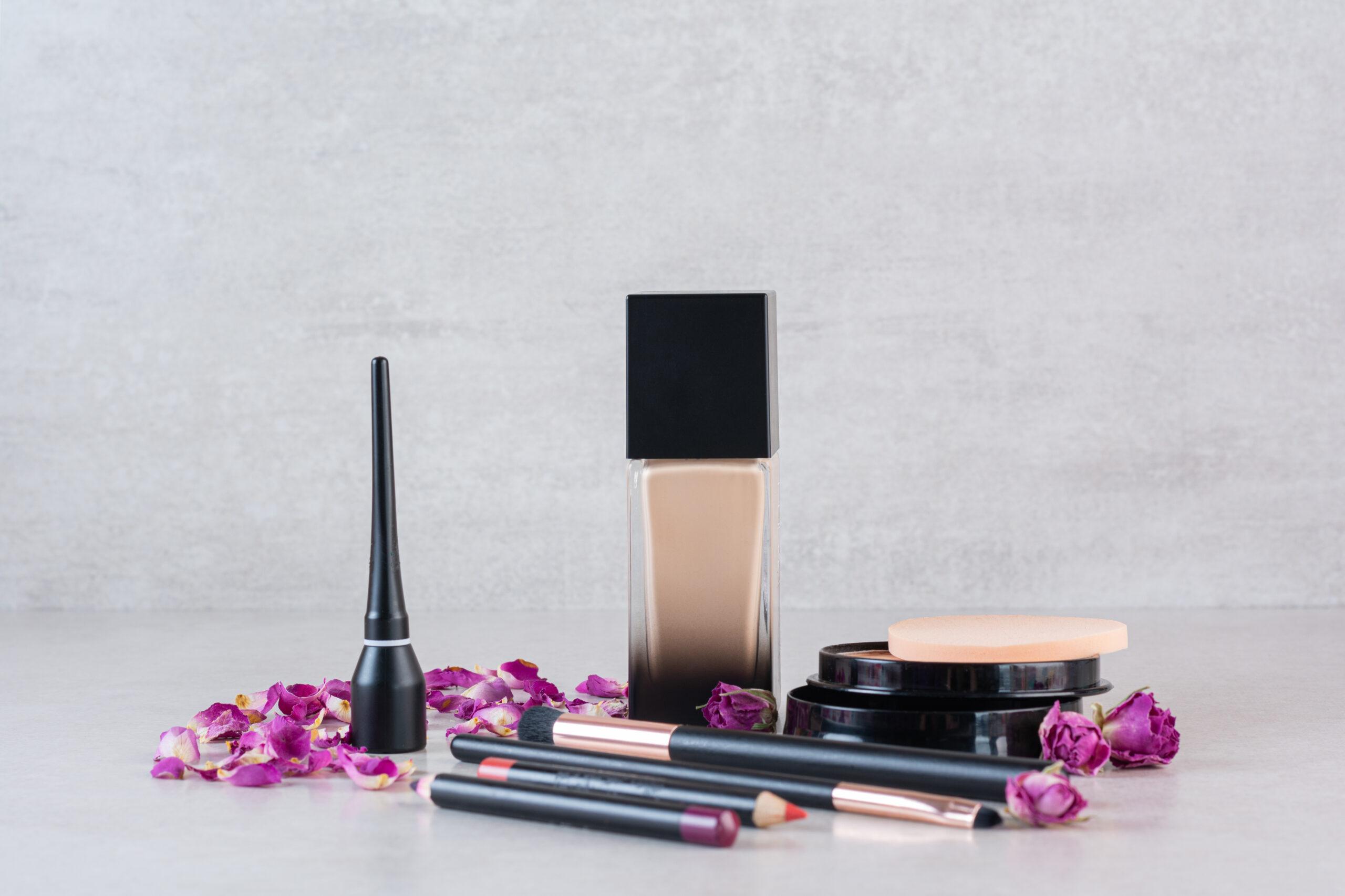 Close up photo of make up products on grey background. High quality photo